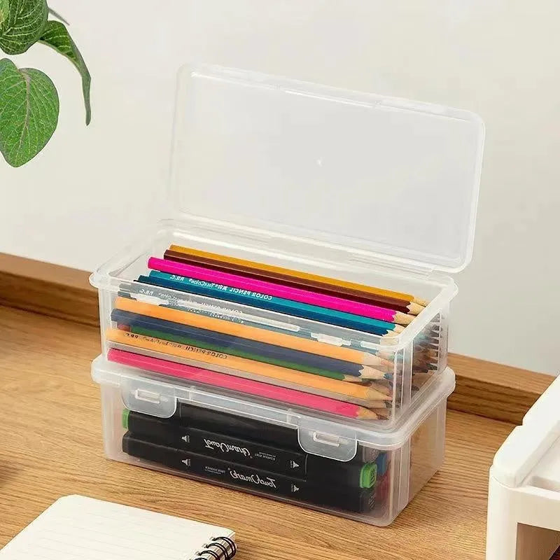 Clear plastic stationery storage box filled with assorted coloured pencils and crayons.
