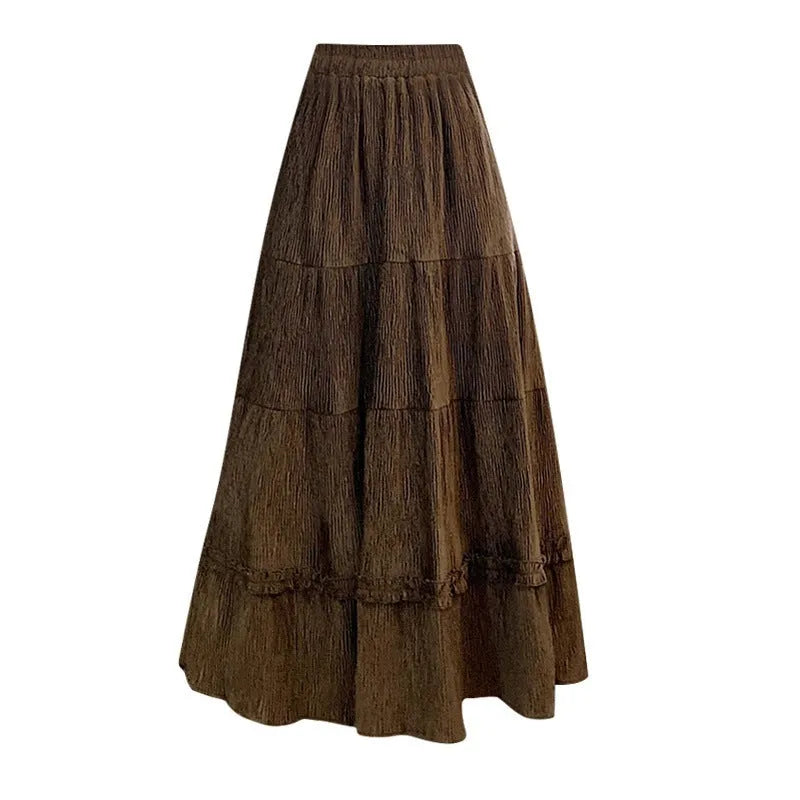 A slimming milky white corduroy A-line midi skirt with an elastic waistband laid flat.