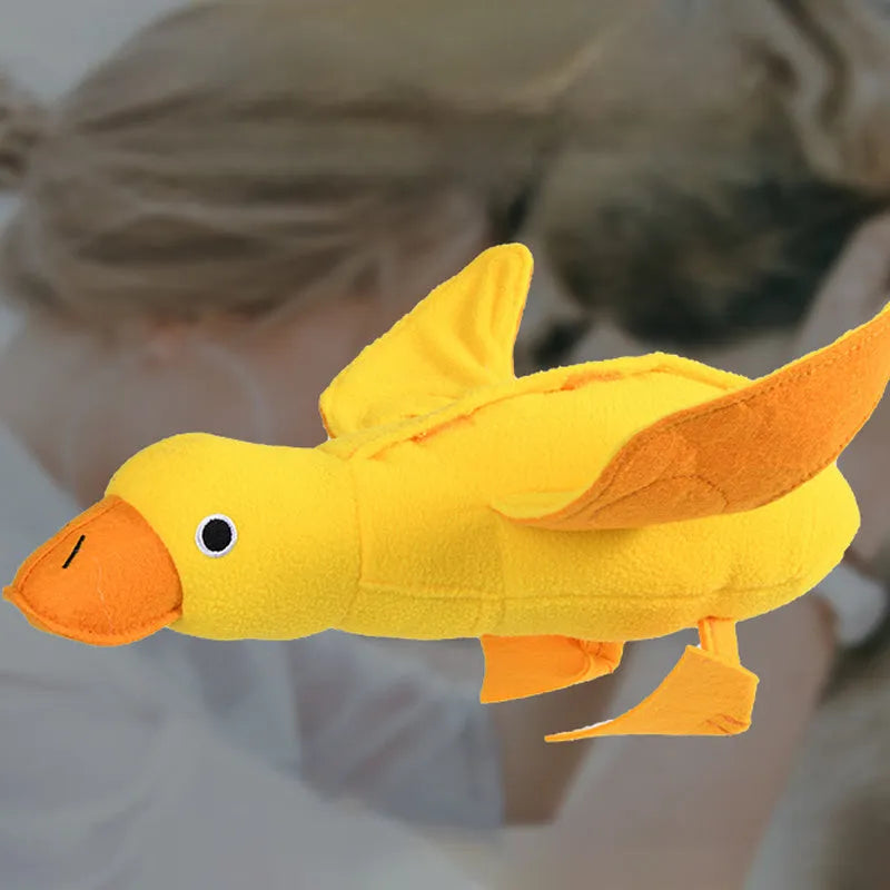 Yellow teddy dog toy with duck sound mechanism and food leak holes for treat dispensing