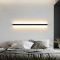 Black 80cm long aluminium LED strip wall lamp mounted on a white wall.