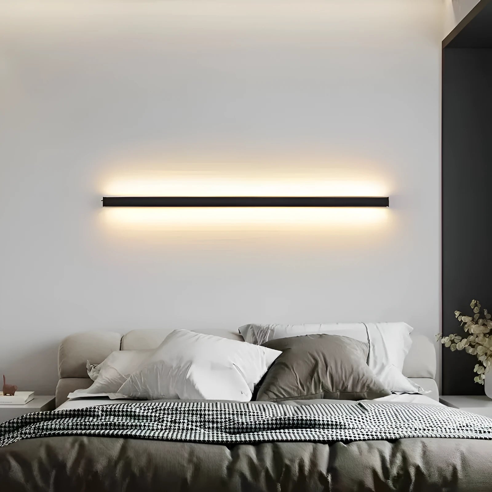 Black 80cm long aluminium LED strip wall lamp mounted on a white wall.