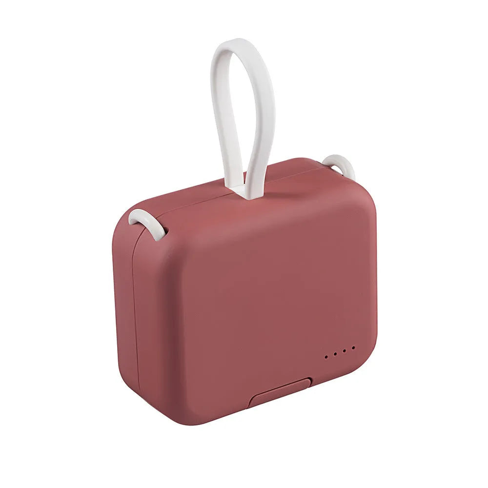 Red portable power bank with an extended bracket holding a mobile phone.