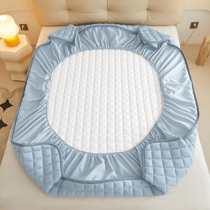 Blue waterproof fitted sheet with elastic corner stretched over a mattress.