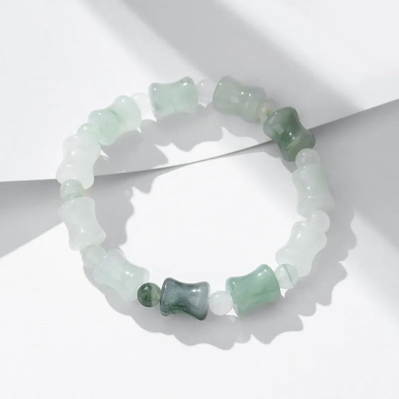 Natural jade and coconut shell beaded bracelet with safety lock clasp on wrist.