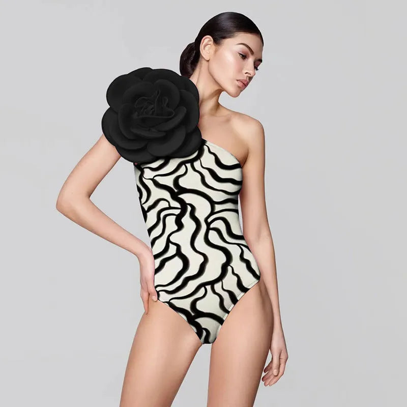 Close-up of a woman's one-piece swimsuit with a three-dimensional floral pattern and a contoured fit.