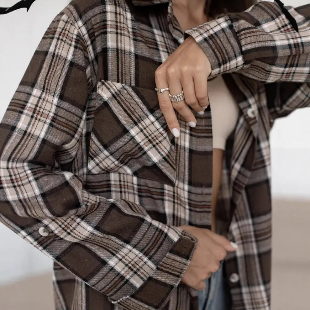 Dark brown retro striped long sleeve women's shirt on a hanger.