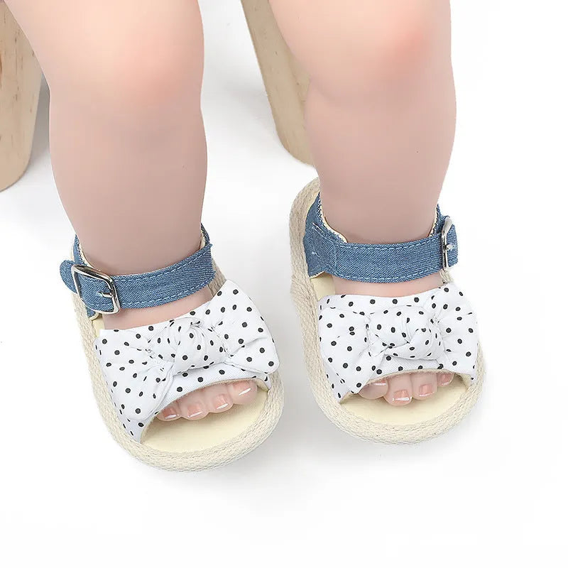 White and black Velcro baby toddler shoes for ages 0-18 months, showing low tube height design.
