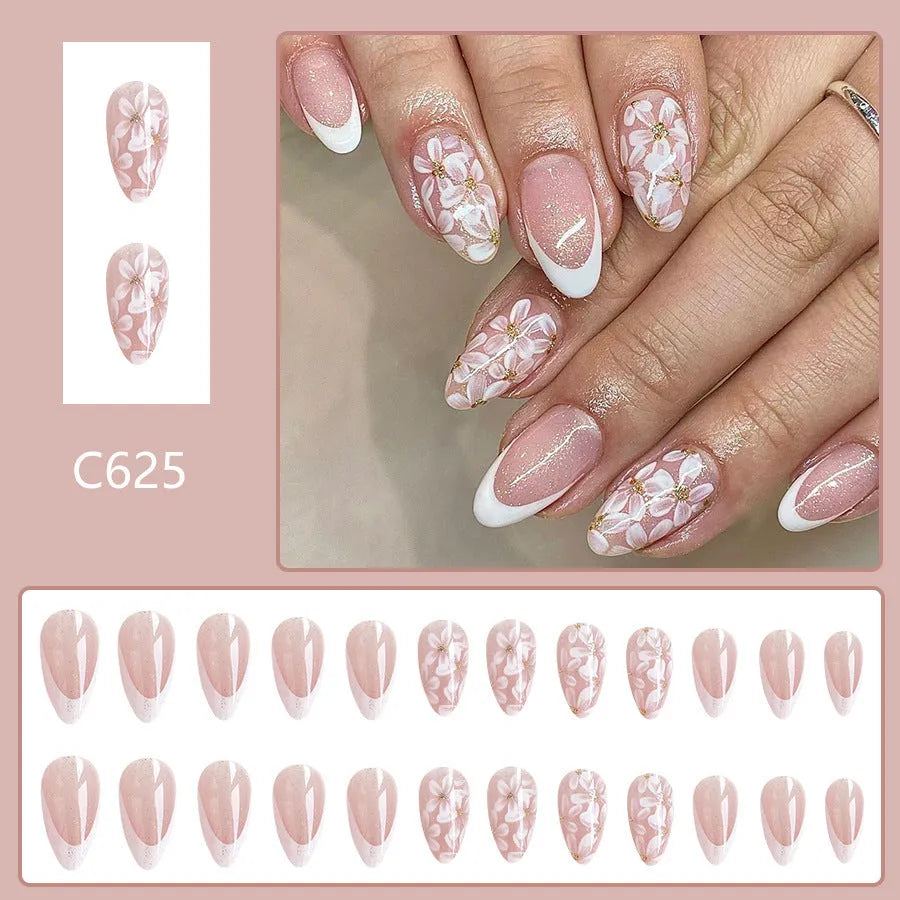 Short glossy almond French style press-on nails with glittering powder flowers in colour C625