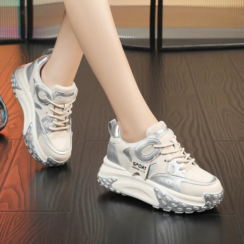 A pair of thick-soled leather sports casual shoes with a wedge heel and round toe in a lace-up design.