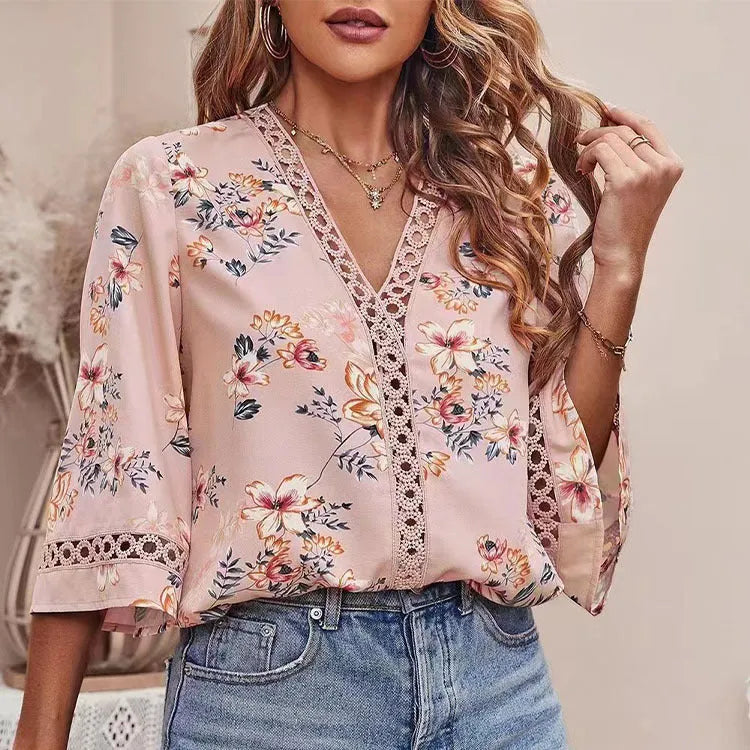Loose V-neck pullover top with bell sleeves, lace trim, and printed pattern in white