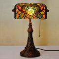 10-inch Tiffany stained glass table lamp on a desk with a warm glow.