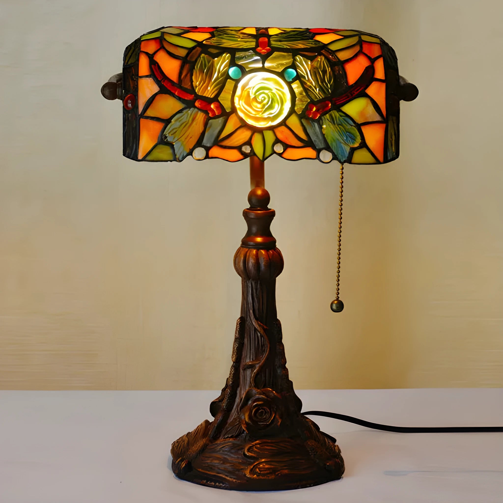 10-inch Tiffany stained glass table lamp on a desk with a warm glow.