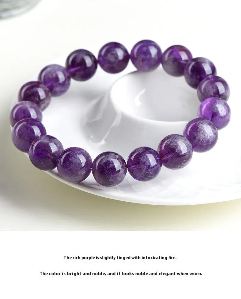 Natural purple feather amethyst crystal bracelet with geometric design and Ruyi element on wrist.