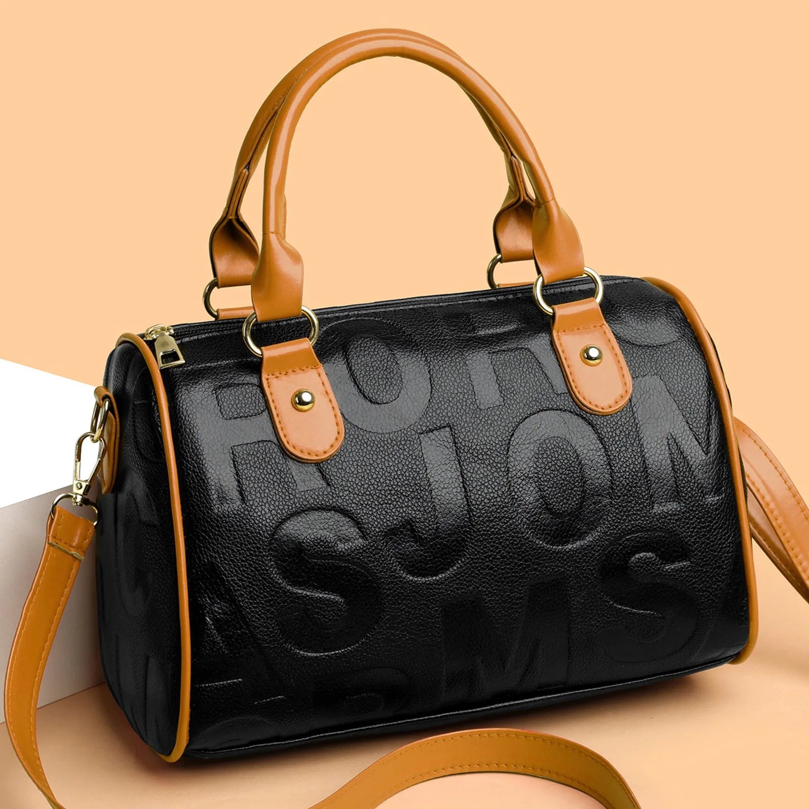 Brown cylindrical crossbody bag with leather-like texture and three shoulder straps