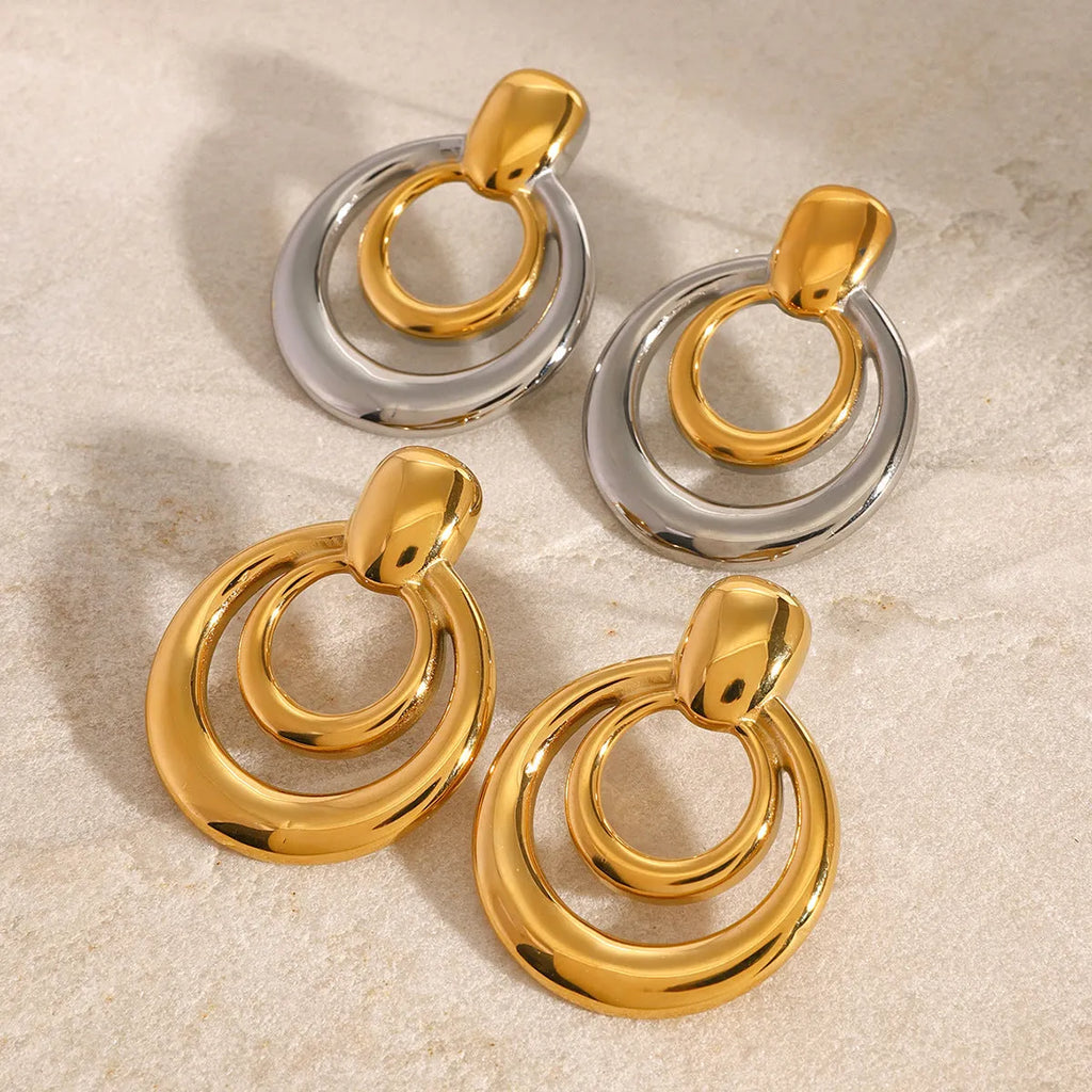 Round double-layer hollow stud earrings with 18K gold electroplated finish on titanium steel