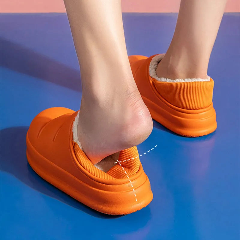 Women's waterproof EVA slippers in various colours with plush lining and a non-slip flat sole.