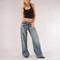 Women's loose blue cotton wide leg trousers with colour block panelling on a low waist.