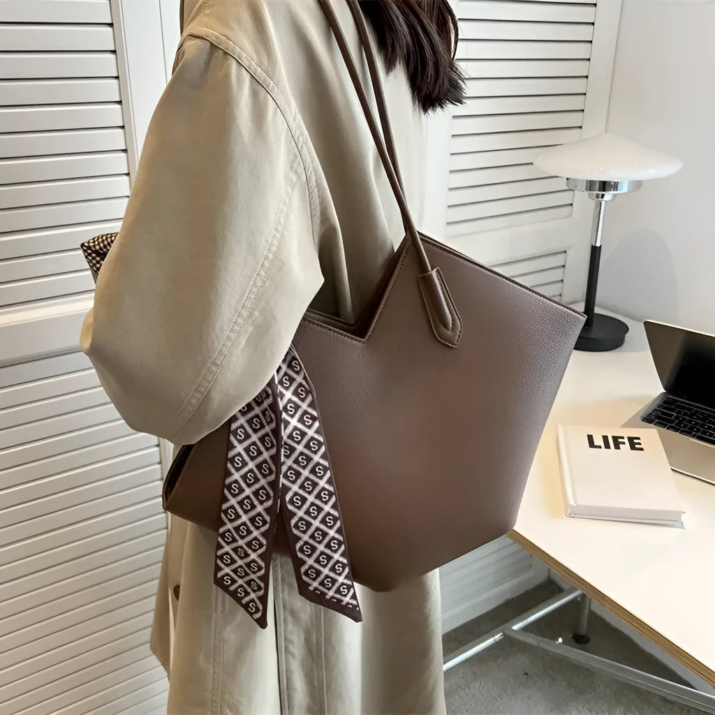 Women's large capacity black PU leather shoulder bag showing front view with external pocket