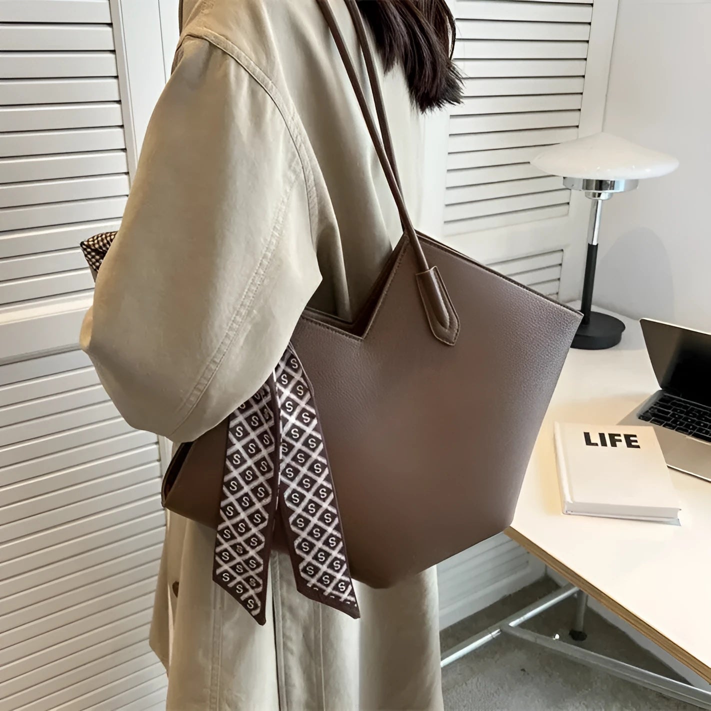 Women's large capacity black PU leather shoulder bag showing front view with external pocket