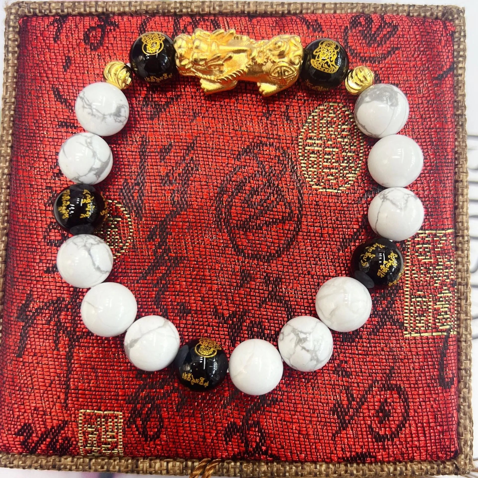 Vintage couple bracelet with white turquoise and black agate stones on a wrist.
