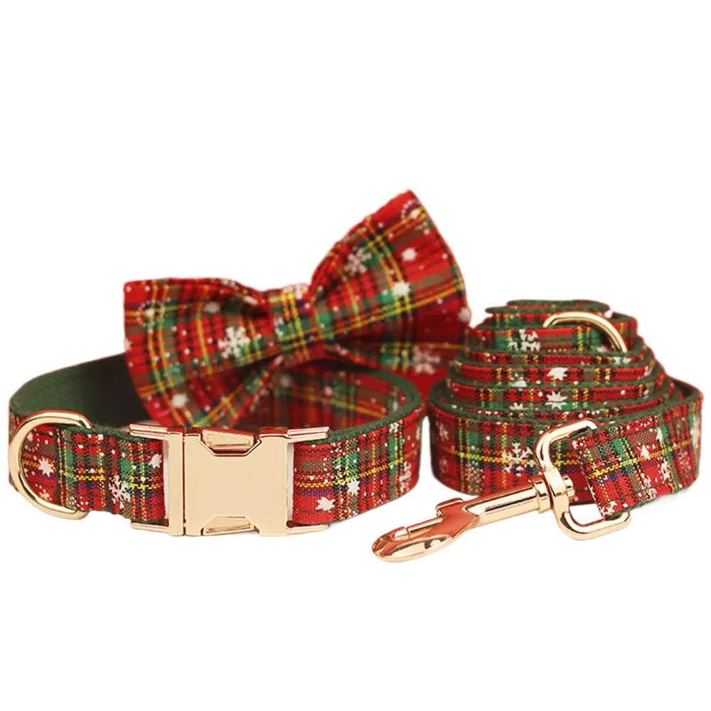 Christmas pet collar four-piece set with green background snowflake design showing dog collar, leash, vest and matching bow