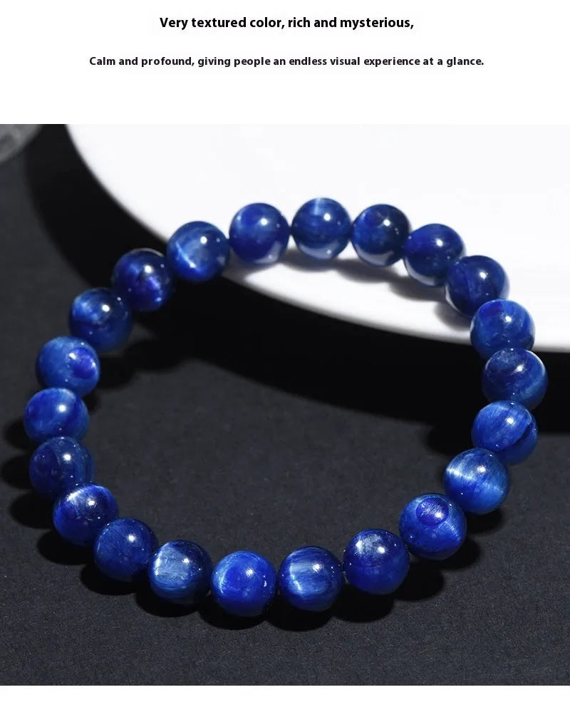 Blue crystal ball bracelet with geometric design and Ruyi motif on a white background.