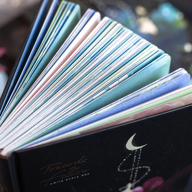 A5 diary book with a luminous purple cover, open to show pages with colour illustrations.