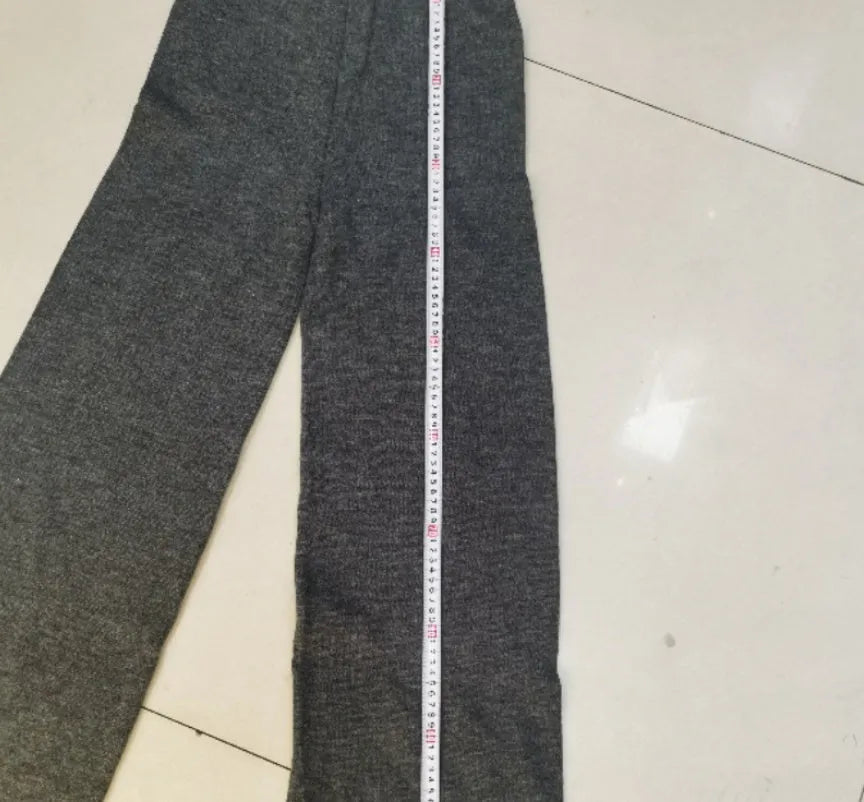 Women's grey side-slit acrylic sweater and matching trousers suit set.