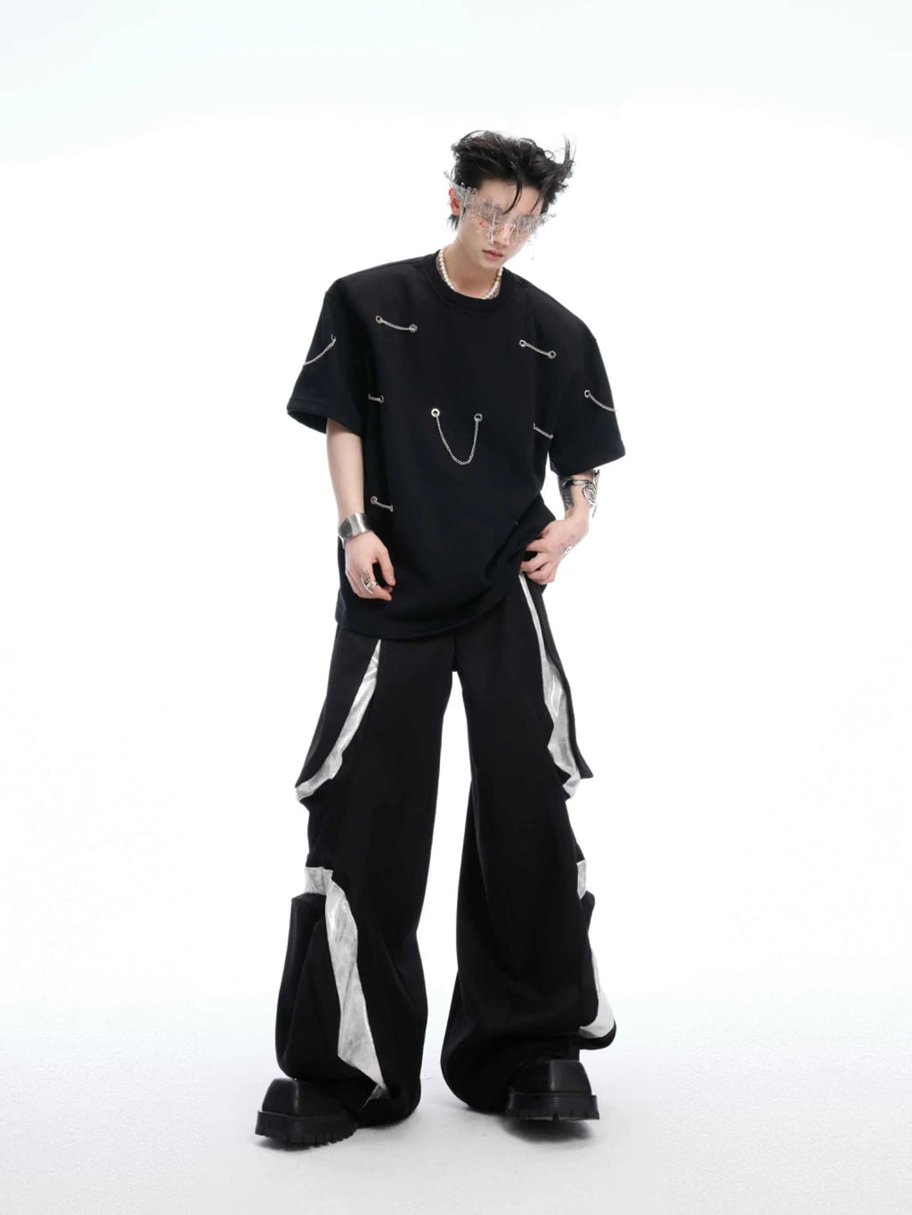 Black T-shirt with padded shoulders and metal chain detail on short sleeves
