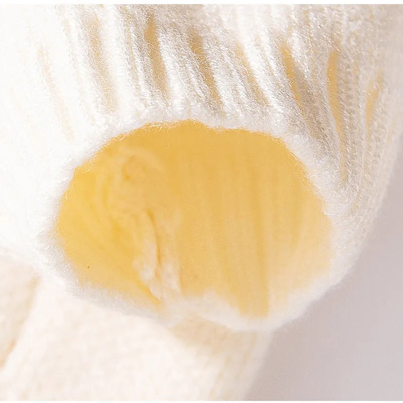 White knitted small dog sweater with rainbow Apple embroidery and green smiley face on a pet
