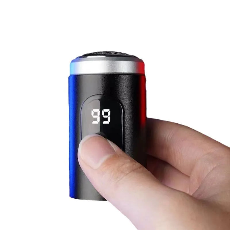 Black portable rechargeable shaver with USB cable and cleaning brush on a white background.