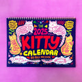 Large A3 cat-themed paper wall calendar for 2024 or 2025 displayed on a wall.