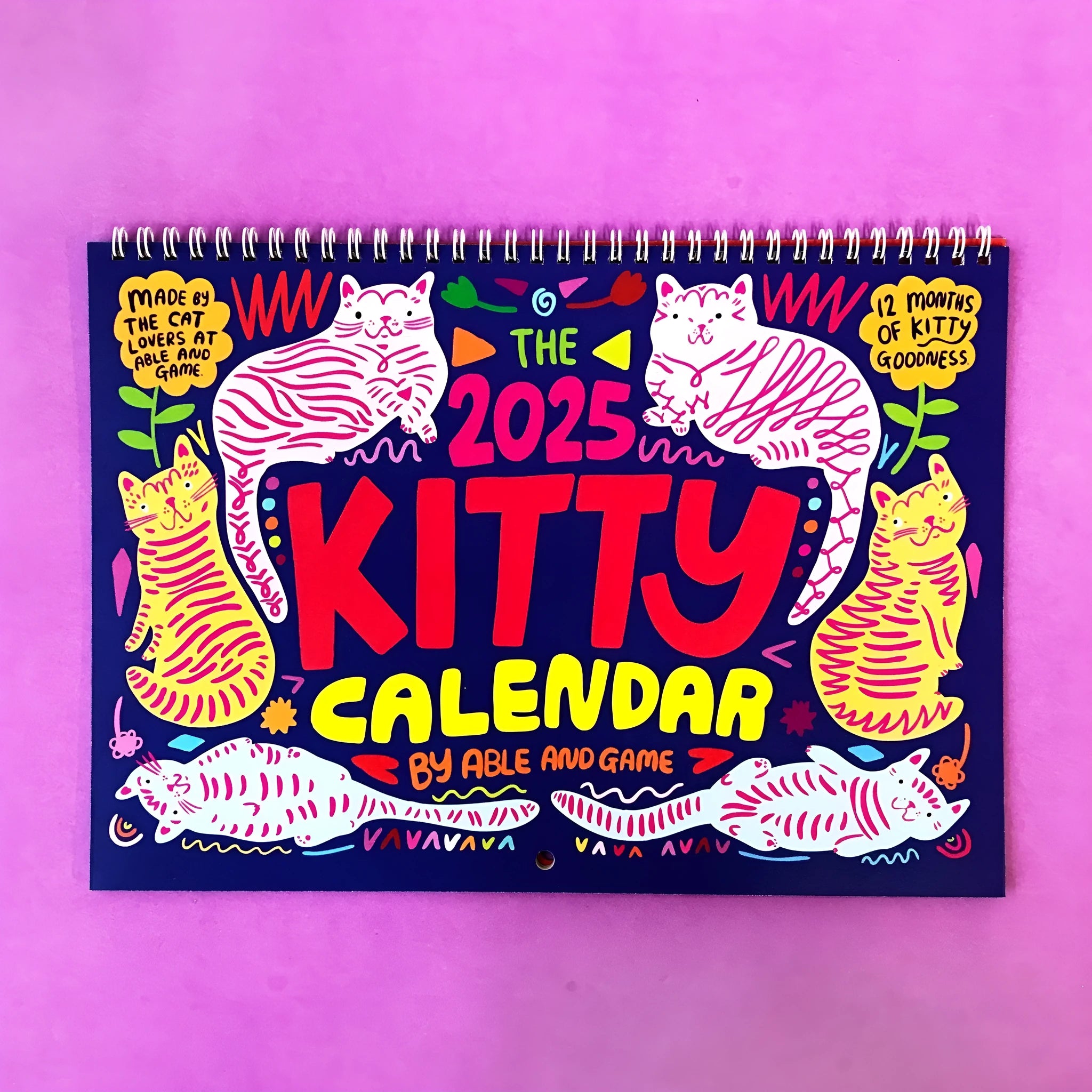 Large A3 cat-themed paper wall calendar for 2024 or 2025 displayed on a wall.