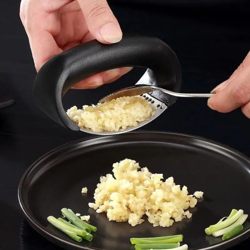 Stainless steel garlic press with ergonomic handle in available colours for kitchen use
