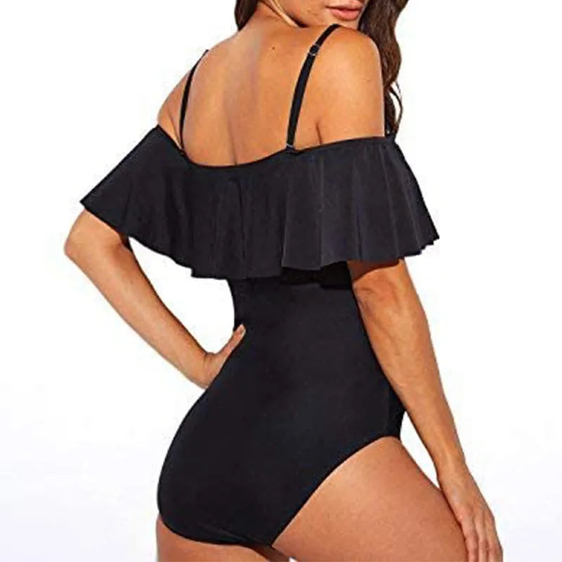 Black one-piece cut-out swimsuit with ruffled straps and tube top style.