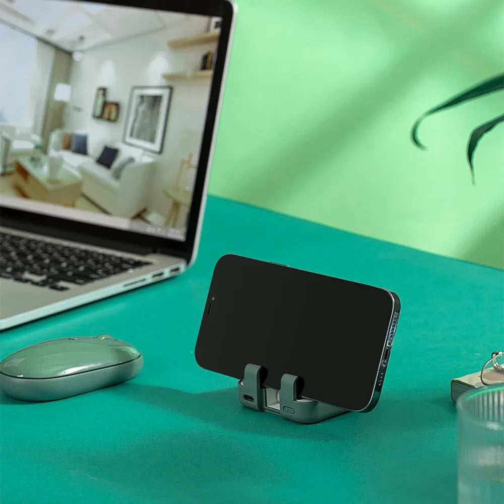 Red portable power bank with an extended bracket holding a mobile phone.
