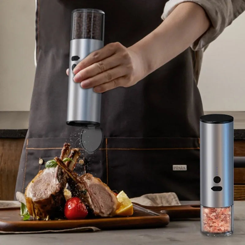 White electric pepper and salt grinder with stainless steel top and clear glass jar showing LED lights