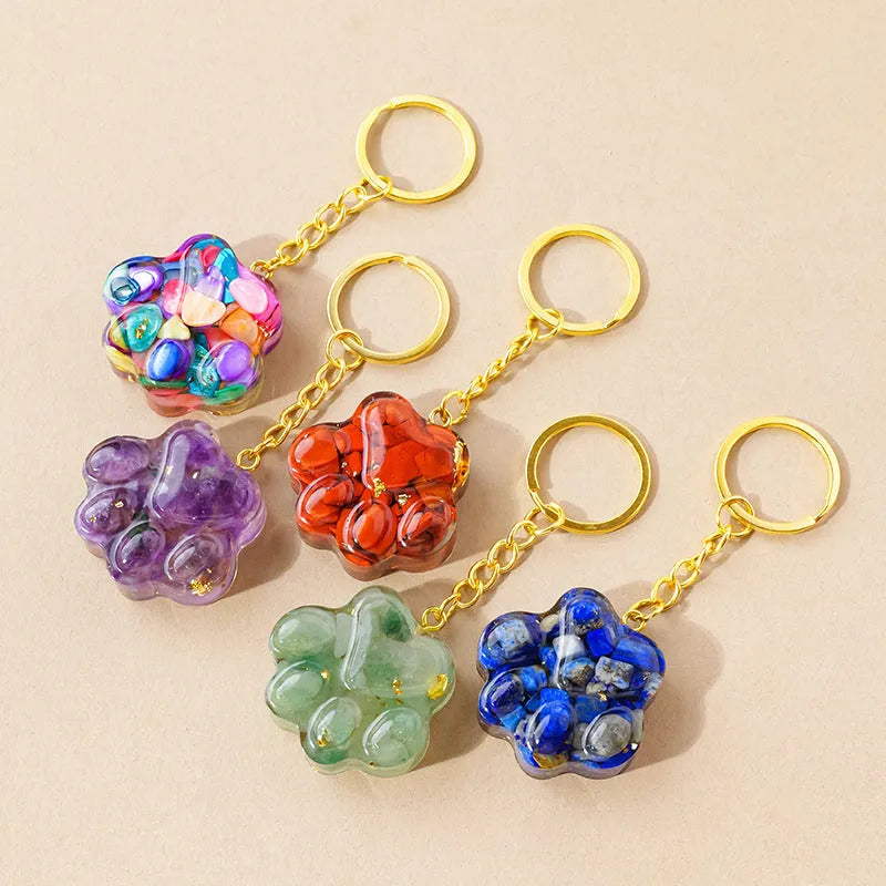 Small natural crystal cat's paw shaped keychain pendant on a keyring.