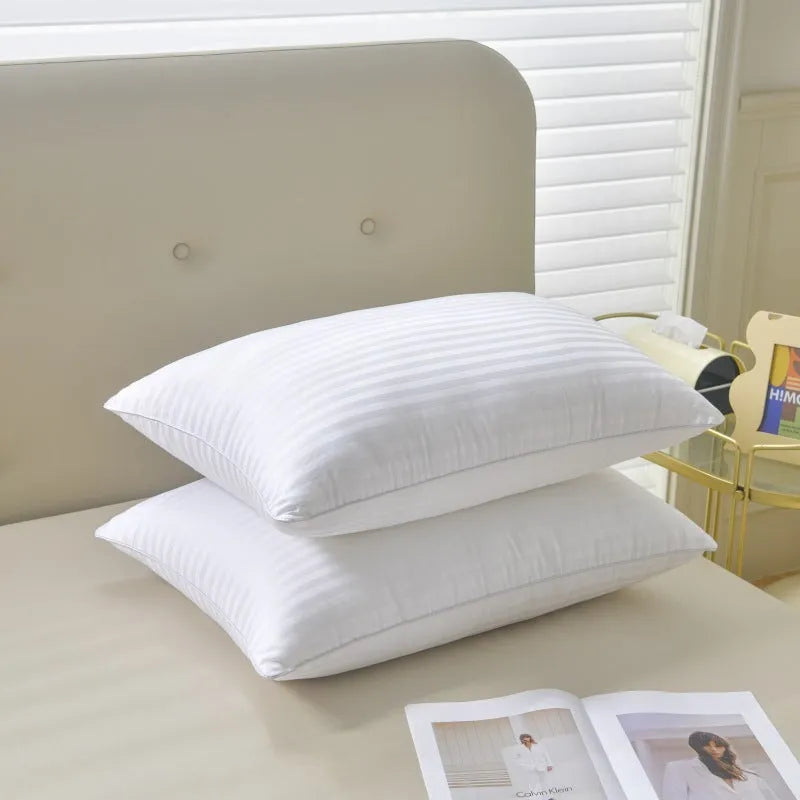 White cotton satin stripe feather pillow showing simple design and hotel-style aesthetic