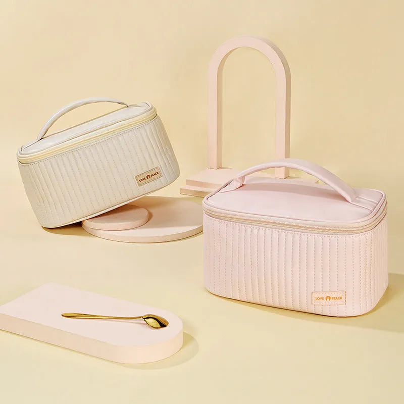 Open-top women's makeup bag in PU leather shown in a selection of solid colours.