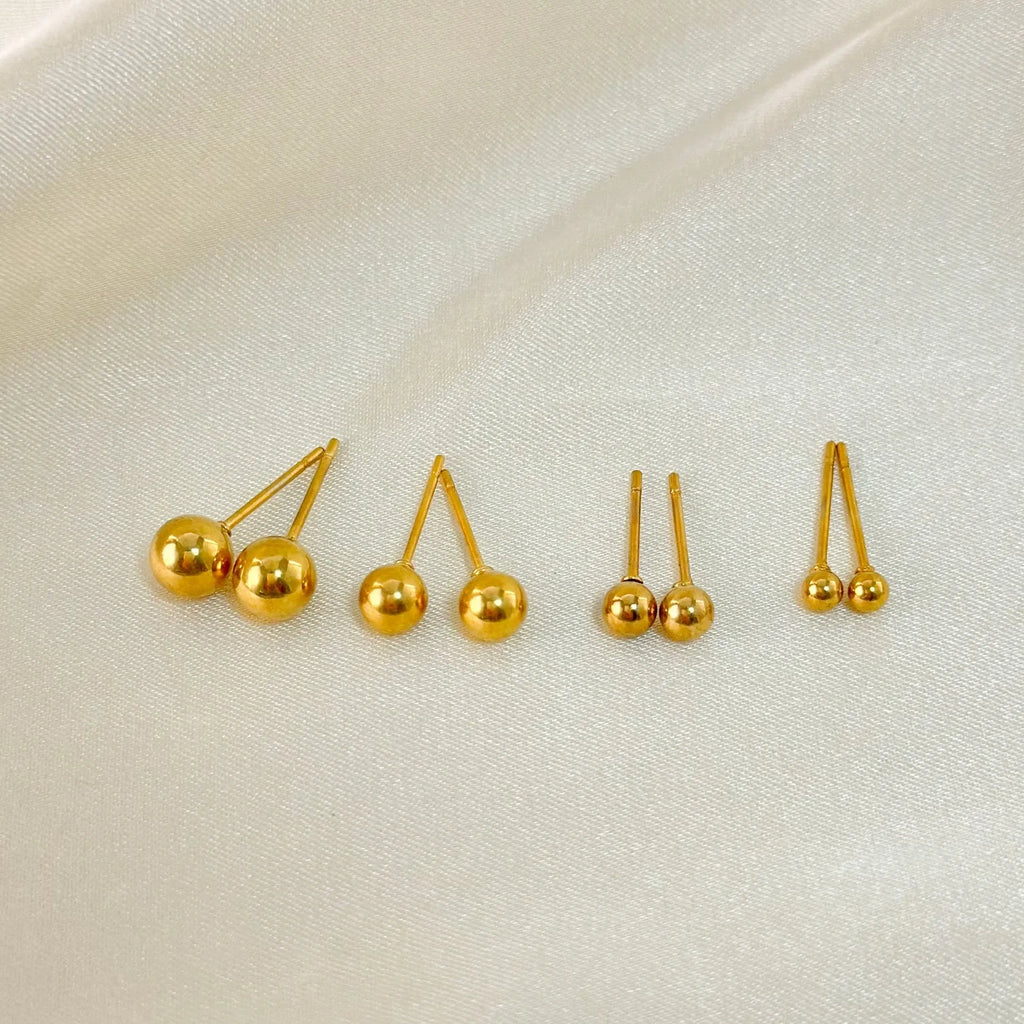 Stainless steel minimalist ball stud earrings with a round geometric shape, shown in various sizes.
