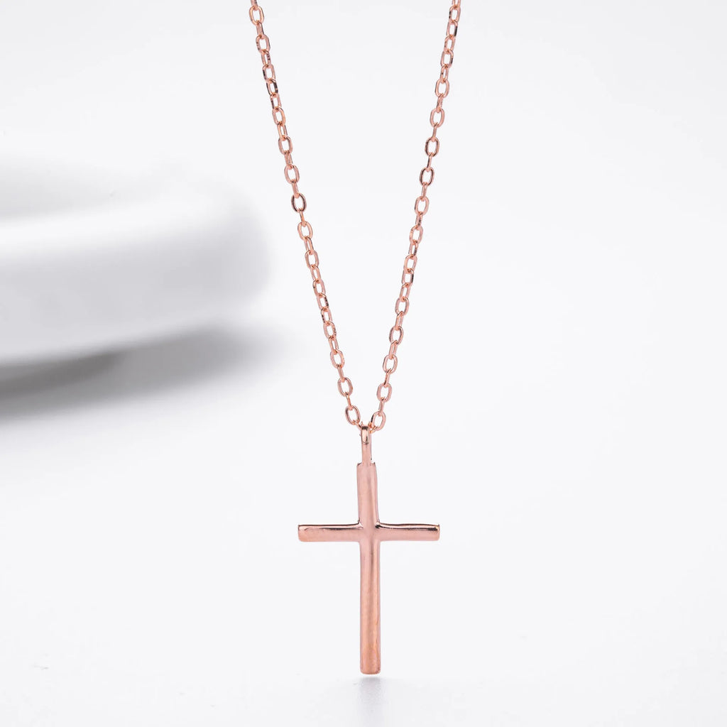 Simple glossy cross pendant on an adjustable O-shaped sterling silver chain.