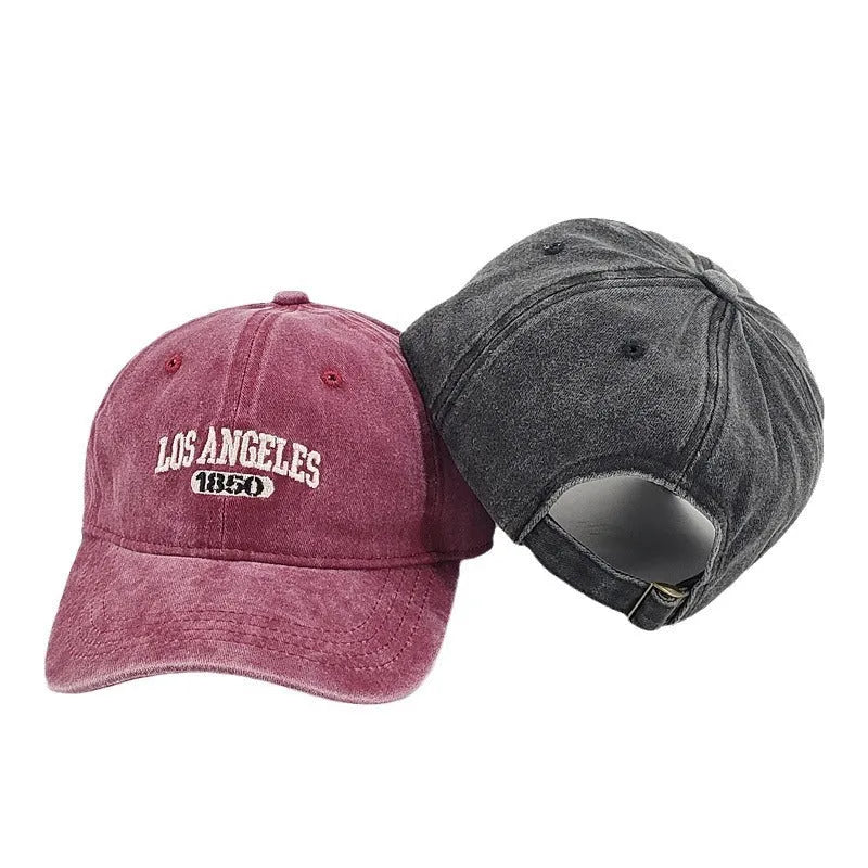 Retro personalised distressed peaked cap with embroidered letters, shown on adjustable strap, in navy blue colour.