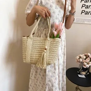 Women's straw crossbody shoulder bag with woven texture in milky white colour showing large capacity interior