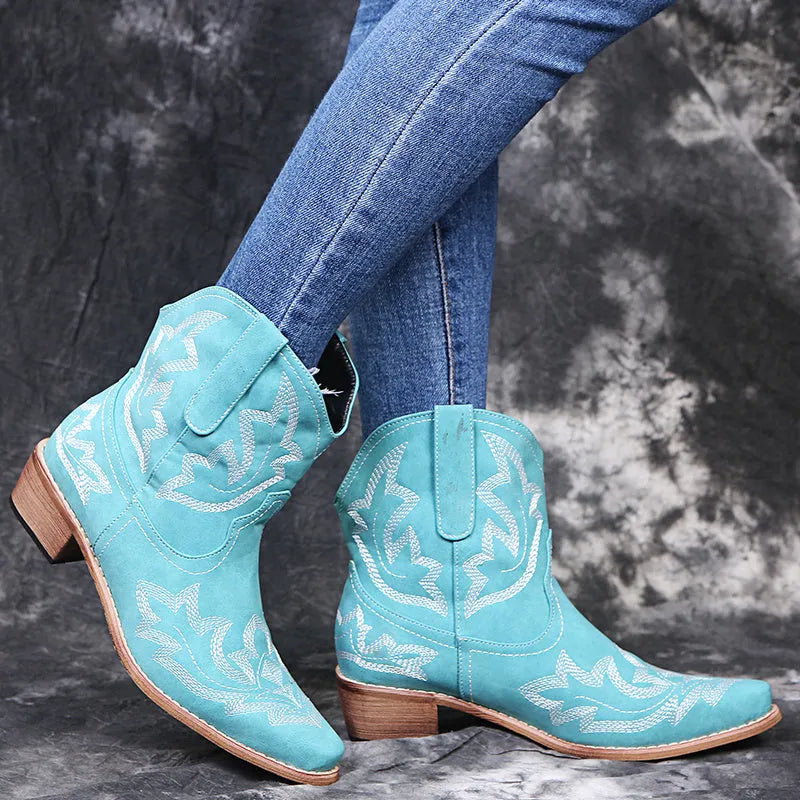 Blue women's Western cowgirl boots with embroidery detail, low wedge heel, and pointed toe.