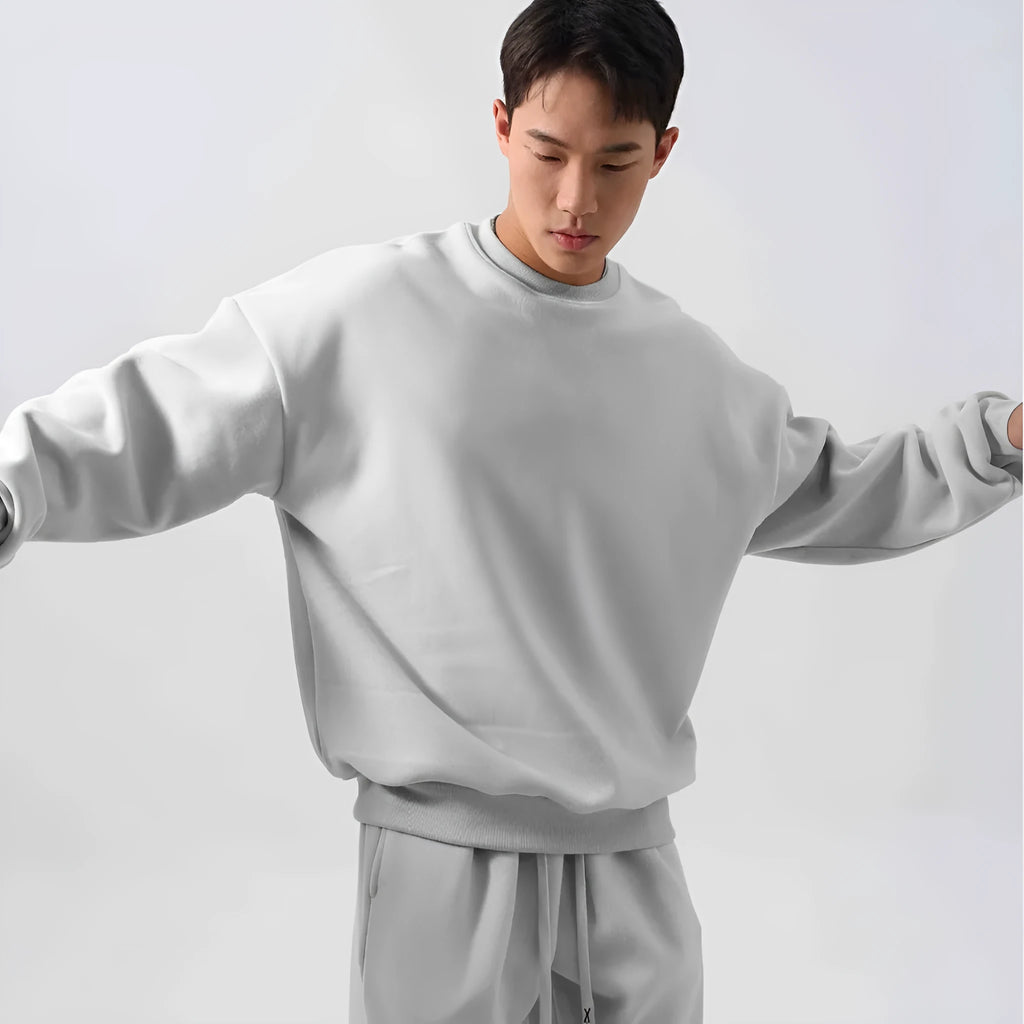 Man wearing a men's army green polar fleece sports suit with long sleeve coat and loose padded trousers.