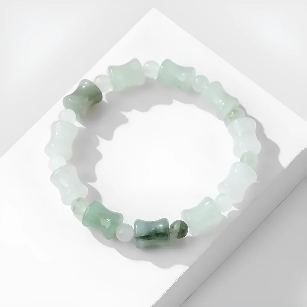 Natural jade and coconut shell beaded bracelet with safety lock clasp on wrist.