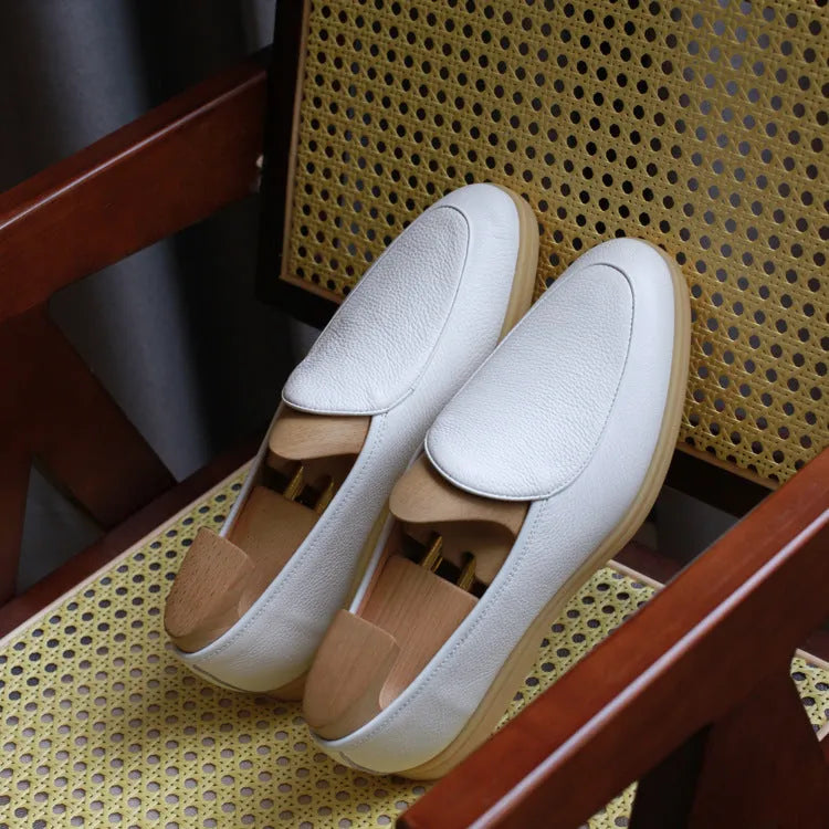 Men's handmade British brown leather loafers with a flat profile and TPR sole.