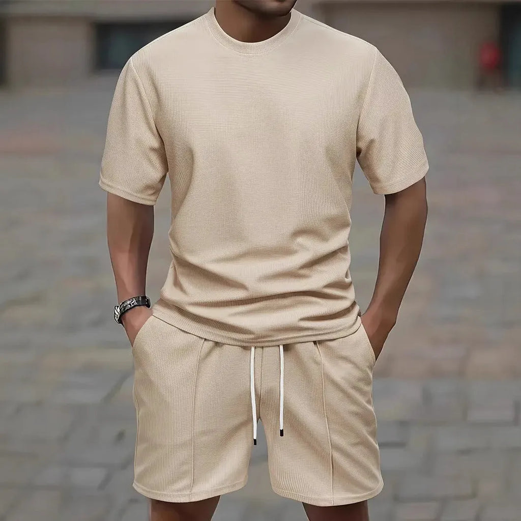 Man wearing a light waffle-texture short sleeve blouse and matching shorts in apricot colour.