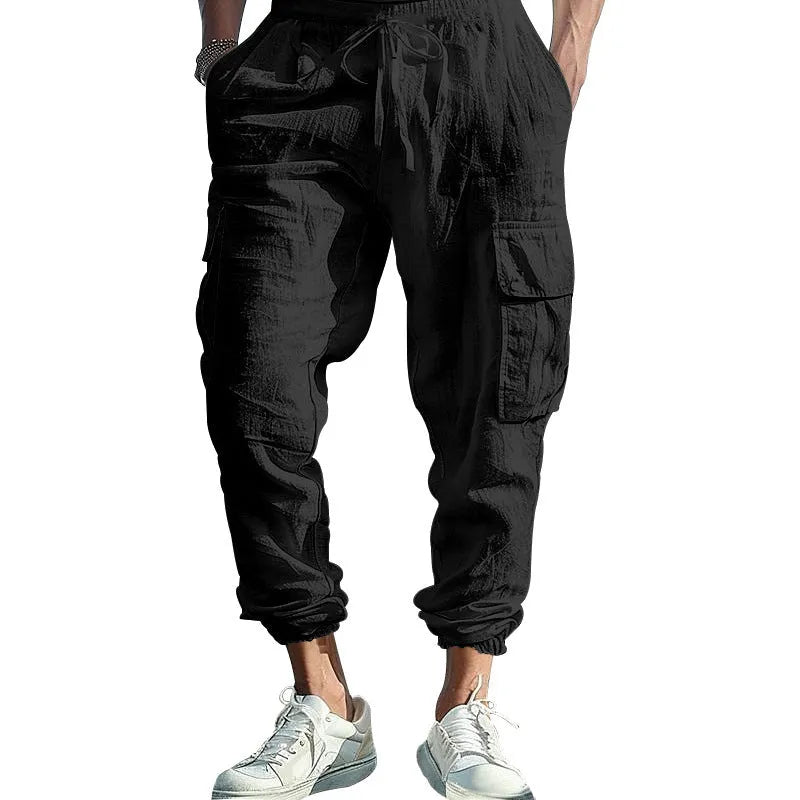 Men's loose-fit linen casual trousers with ankle ties and multiple pockets in a solid colour.